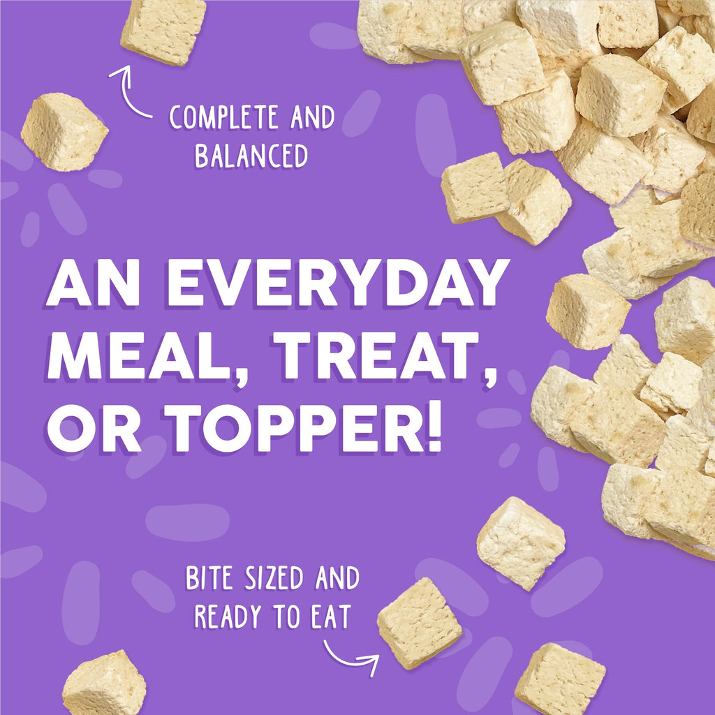 Weruva Paw Lickin' Chicken Freeze Dried cat food cubes on a purple background. “An everyday meal, treat, or topper! Complete and balanced. Bite sized and ready to eat.” Ideal for those wanting quality chicken breast cat food.