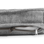 a close up of a grey snooz pad with the outer cover partially unzipped