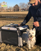Man outdoors with his dog next to a DogGoods foldable crate. The dog stands attentively, wearing a red collar, with a heartfelt message about being a hero to your pet.