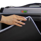 Close-up of a hand adjusting the soft fleece mat inside a DogGoods foldable crate. The mat is zippered, liquid-resistant, and fully washable for pet comfort.