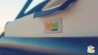 Close-up of the DogGoods logo stitched onto the foldable dog crate. The durable fabric and sturdy handle highlight the brand's quality and design.