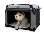 Small white dog resting inside a DogGoods foldable crate with roll-up mesh screens for ventilation and a soft fleece mat for comfort.