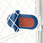 A royal blue Groov Training Aid attached to a white dog crate