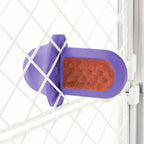A Lavender Groov Training Aid attached to a white dog crate