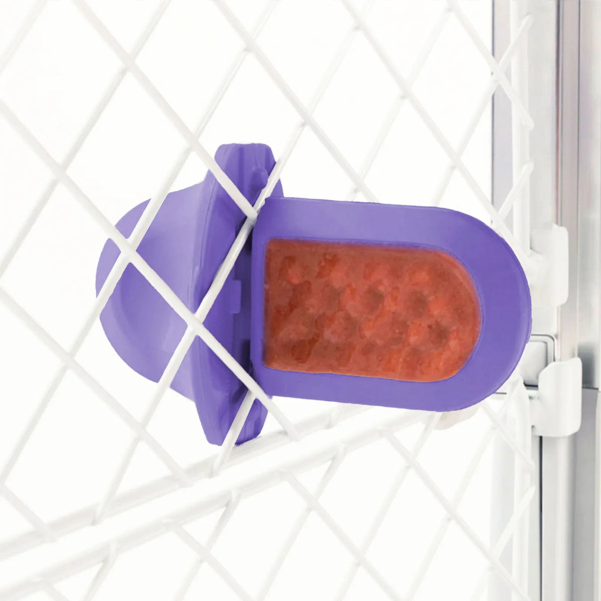 A Lavender Groov Training Aid attached to a white dog crate