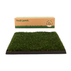 Grass patch on a black tray with 'fresh patch' packaging above  on a white background