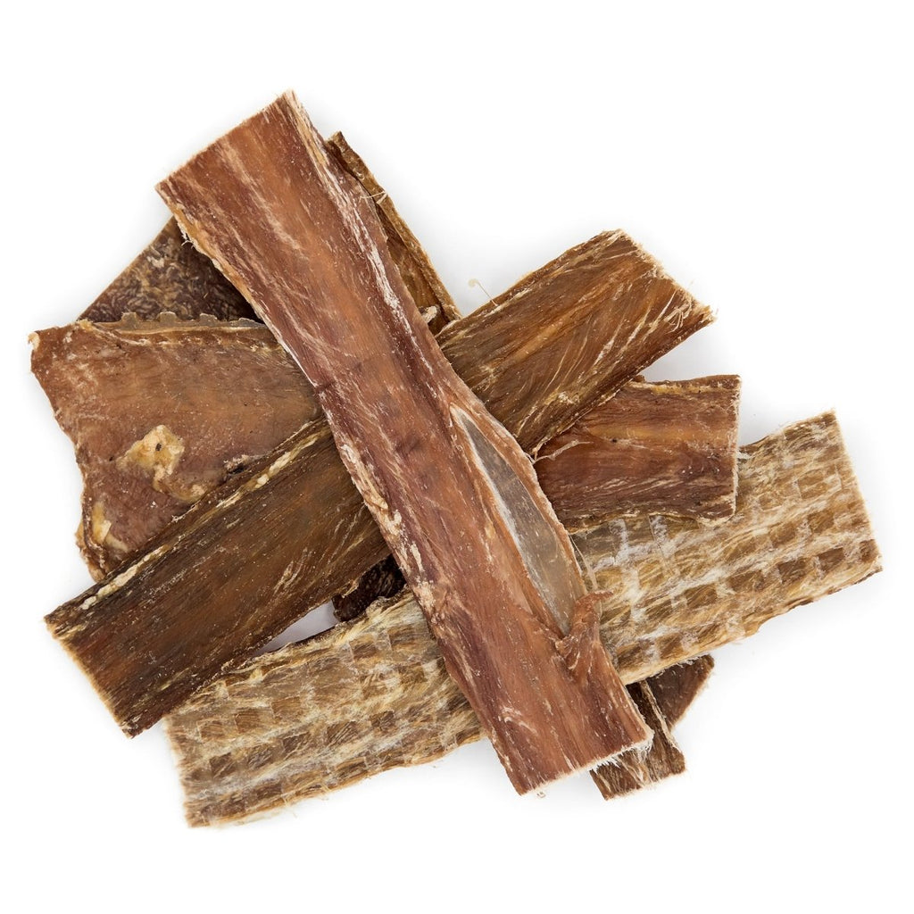A pile of brown pieces of wood resembling Best Bully Sticks 5-6 Inch Beef Jerky Gullet Strips dog treats.
