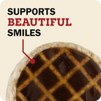 A close-up of a Redbarn Roofle treat. Large text at the top reads 'SUPPORTS BEAUTIFUL SMILES' on a warm cream background.