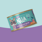 A single can of NALA brand adult cat food, specifically Tuna & Salmon Recipe, shown at an angle against a split pastel blue and purple background.