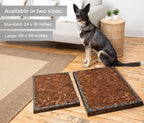 German Shepherd sitting beside two Bark Potty disposable dog potties in standard and large sizes on hardwood flooring.