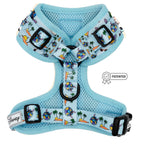 The Sassy Woof Dog Adjustable Harness - Disney's Stitch features a light blue tropical print with palm trees, surfboards, and Stitch characters. It includes black buckles, a patented badge, and Disney tag for style and comfort.