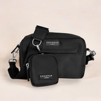 Black Cocopup London dog walking bag with matching treat pouch, displayed on a light beige background.