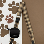 Black Cocopup London dog walking bag with a plaid strap, designed for carrying treats or dispensing poop bags.