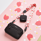 Black Cocopup London dog walking bag with a coin pouch and a pink strap featuring red strawberry designs.