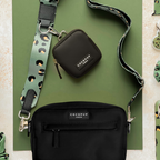 Black Cocopup London dog walking bag with a green and black leopard-print strap and attached poop bag dispenser.