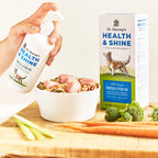 Dr. Harvey's Health & Shine Omega-3 Fish Oil pump bottle being added to a bowl of raw dog food
