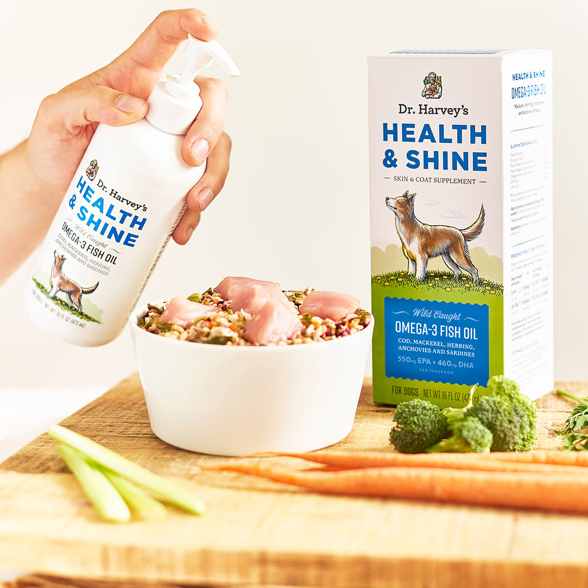 Dr. Harvey's Health & Shine Omega-3 Fish Oil pump bottle being added to a bowl of raw dog food