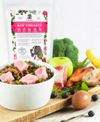 Dr. Harvey's Raw Vibrance grain-free dog food mix bag with bowl of raw meat, vegetables, blueberries, apple, egg, and bone.