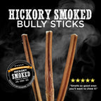 Four Hickory Smoked Sampler Box chews from Best Bully Sticks are shown upright with smoke, product branding, a five-star review, and a customer quote. Try our long-lasting treats your dog will love!.