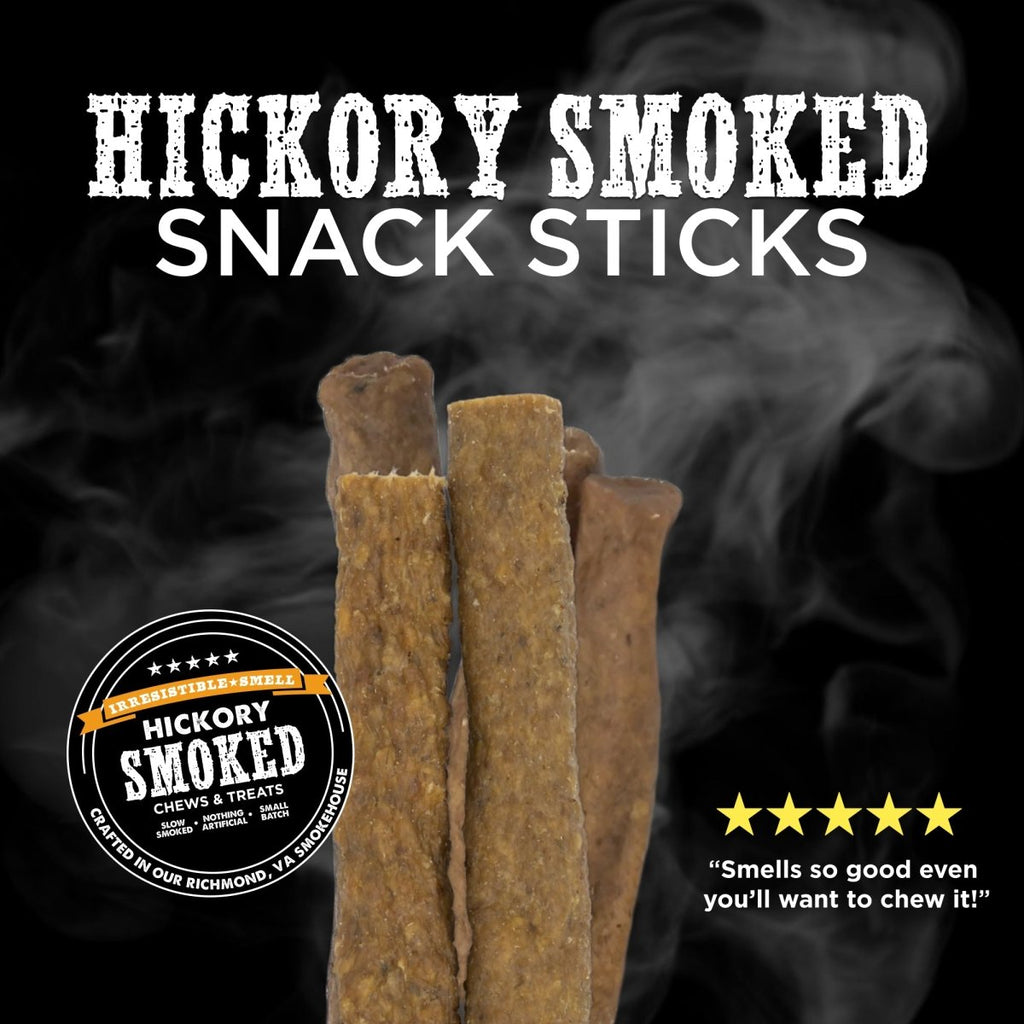 Four hickory smoked snack sticks from Best Bully Sticks’ Hickory Smoked Sampler Box stand upright against a smoky black background, with bold text and a five-star review—ideal for fans of Bully Sticks and smoked dog chews.