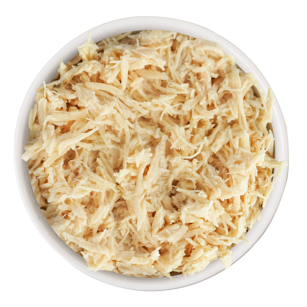 A white bowl filled with finely shredded boneless Weruva Paw Lickin' Chicken, seen from above on a white background—ideal for classic recipes or pairing with savory gravy.