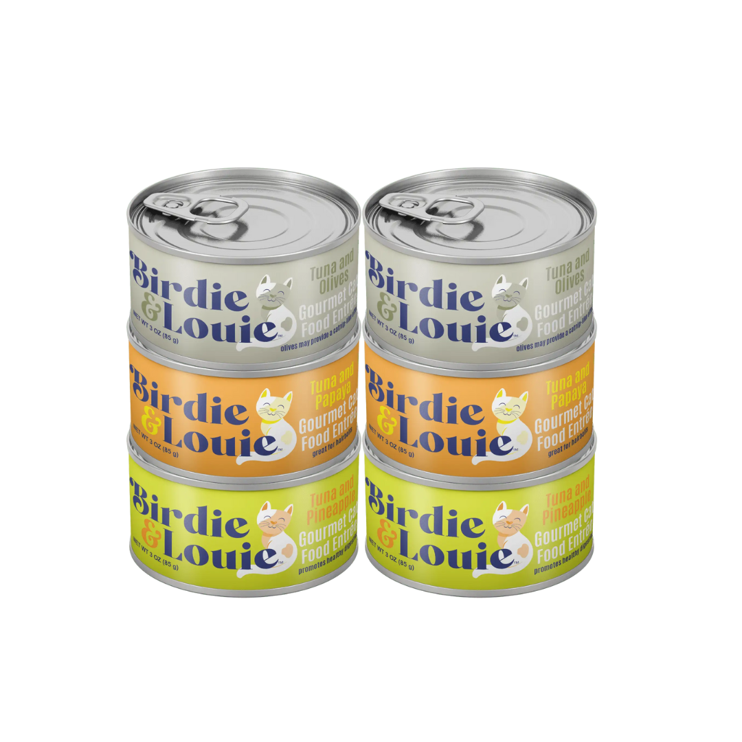 Stacks of Birdie & Louie canned cat food with labels indicating different flavors, such as Tuna and Papaya, Tuna and Pineapple, and Tuna and Olive.