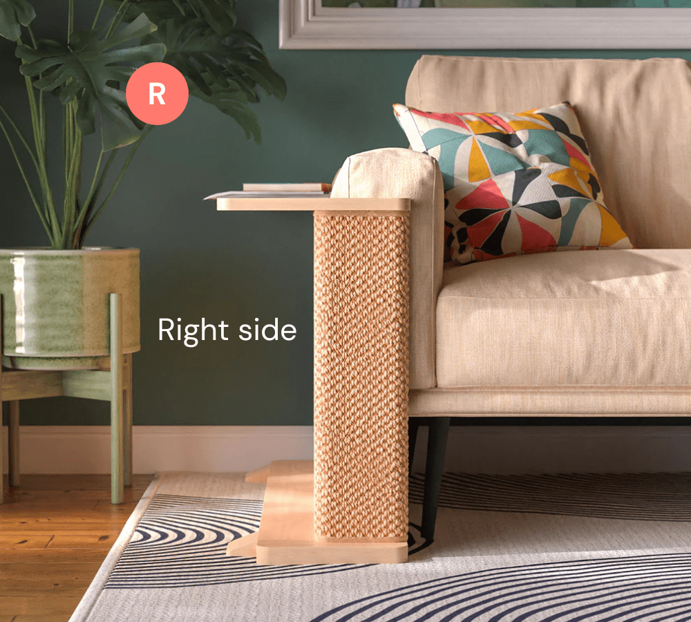 A Cat-e-Corner table placed next to a sofa, integrating a cat's scratching post with a small table, in a room with a plant and a colorful cushion.