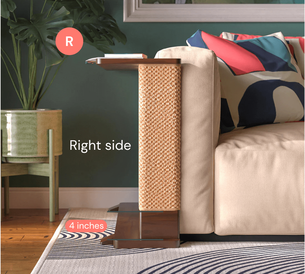 A Cat-e-Corner table placed next to a sofa, integrating a cat's scratching post with a small table, in a room with a plant and a colorful cushion.
