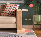 A Cat-e-Corner table placed next to a sofa, integrating a cat's scratching post with a small table, in a room with a plant and a colorful cushion.