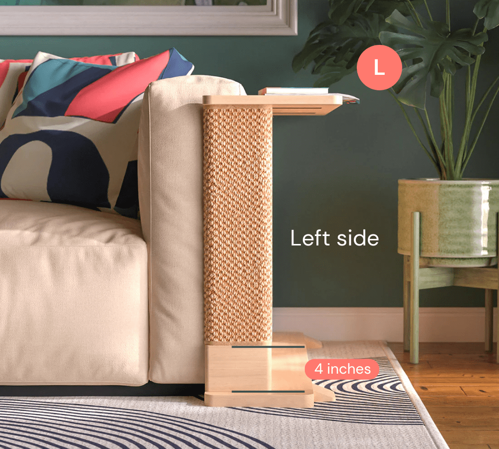 A Cat-e-Corner table placed next to a sofa, integrating a cat's scratching post with a small table, in a room with a plant and a colorful cushion.