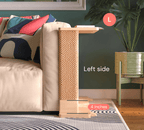 A Cat-e-Corner table placed next to a sofa, integrating a cat's scratching post with a small table, in a room with a plant and a colorful cushion.