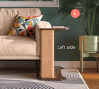 A Cat-e-Corner table placed next to a sofa, integrating a cat's scratching post with a small table, in a room with a plant and a colorful cushion.