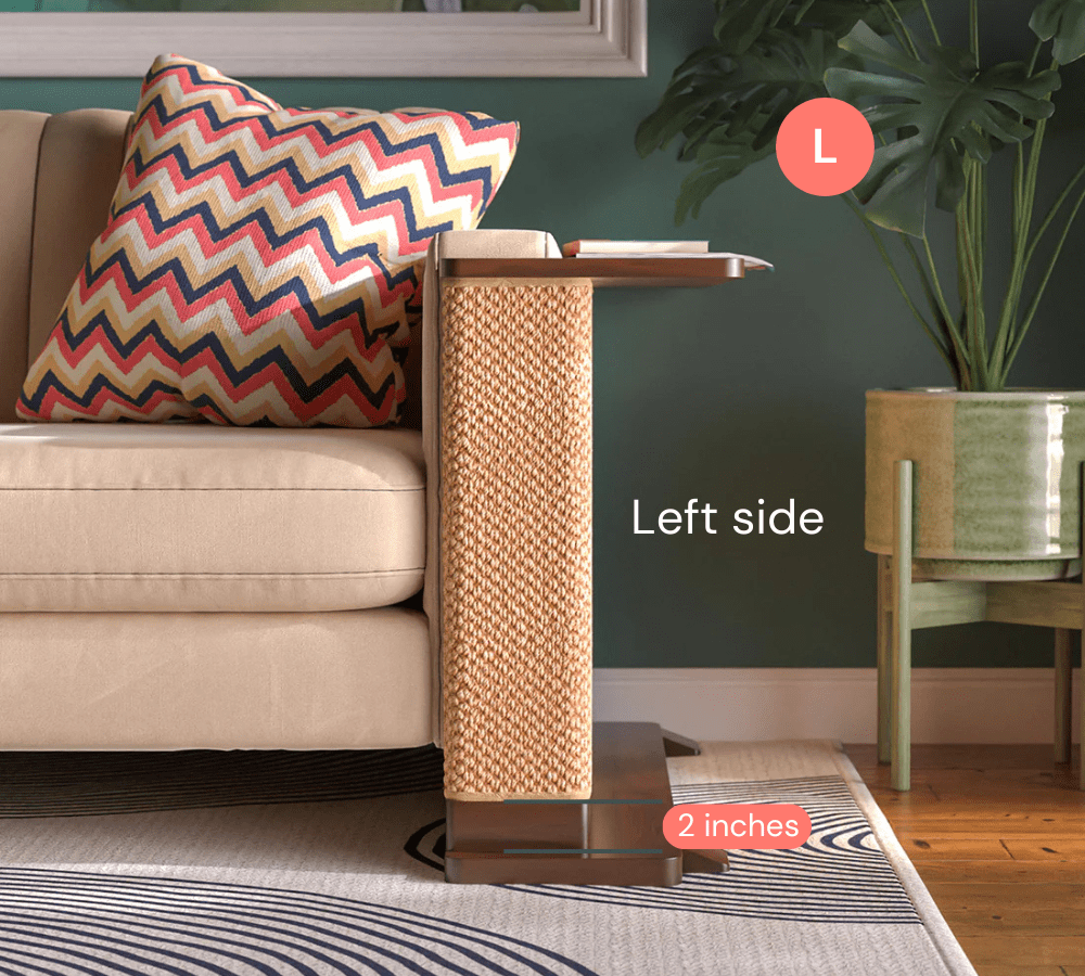 A Cat-e-Corner table placed next to a sofa, integrating a cat's scratching post with a small table, in a room with a plant and a colorful cushion.