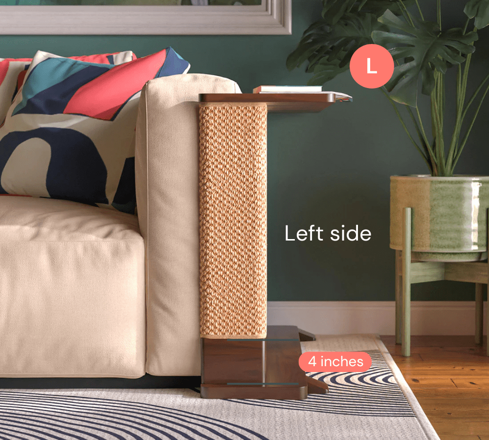 A Cat-e-Corner table placed next to a sofa, integrating a cat's scratching post with a small table, in a room with a plant and a colorful cushion.