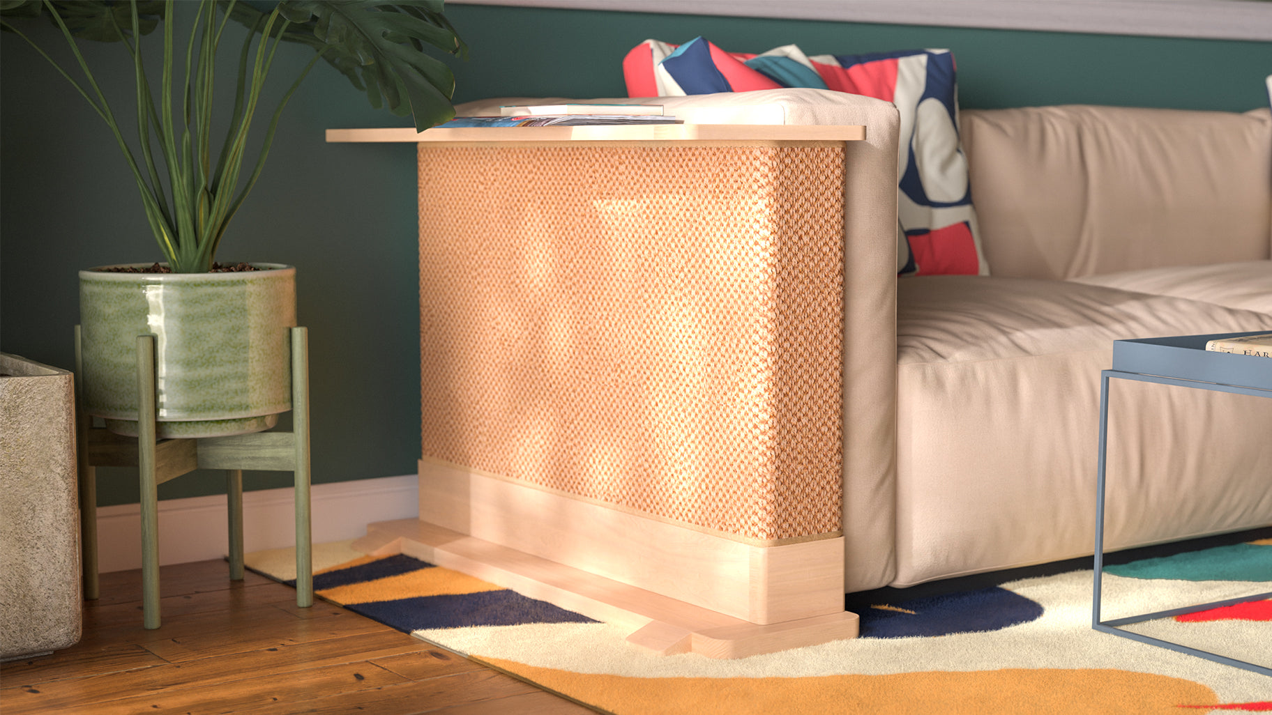 A Cat-e-Corner table placed next to a sofa, integrating a cat's scratching post with a small table, in a room with a plant and a colorful cushion.