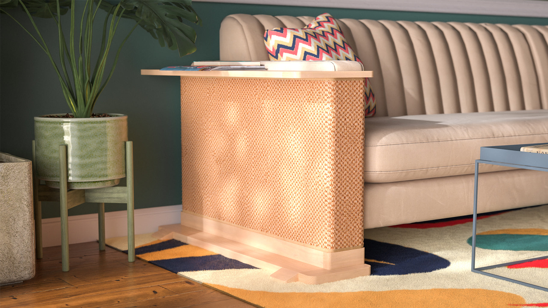 A Cat-e-Corner table placed next to a sofa, integrating a cat's scratching post with a small table, in a room with a plant and a colorful cushion.