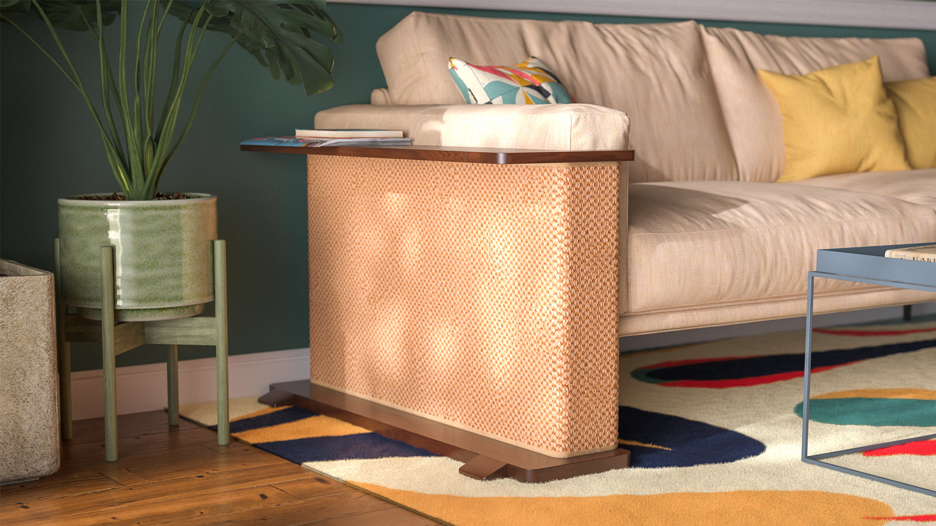 A Cat-e-Corner table placed next to a sofa, integrating a cat's scratching post with a small table, in a room with a plant and a colorful cushion.