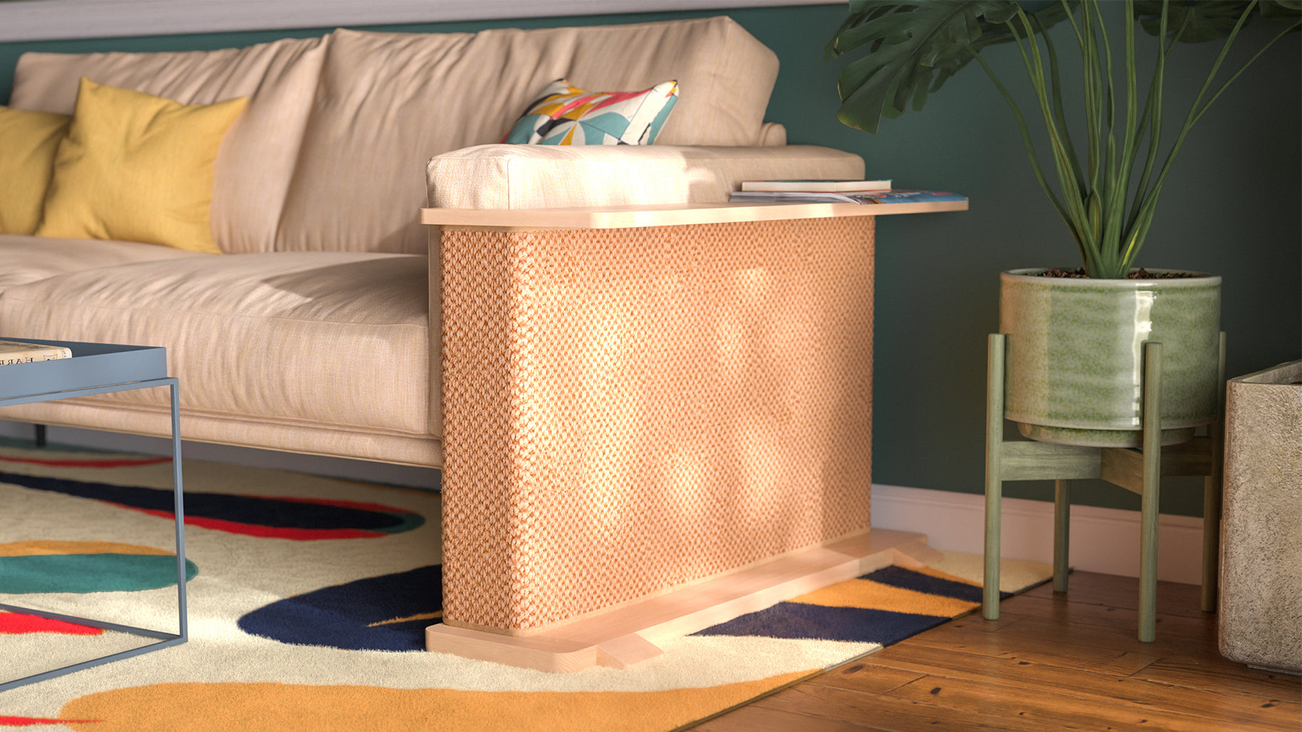 A Cat-e-Corner table placed next to a sofa, integrating a cat's scratching post with a small table, in a room with a plant and a colorful cushion.