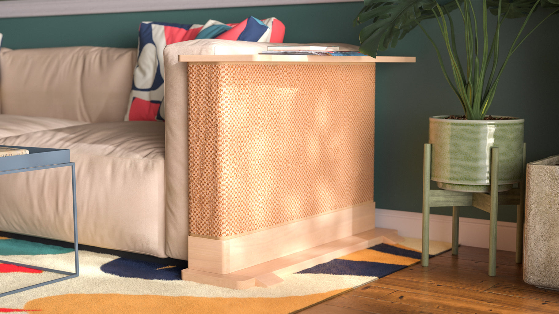 A Cat-e-Corner table placed next to a sofa, integrating a cat's scratching post with a small table, in a room with a plant and a colorful cushion.