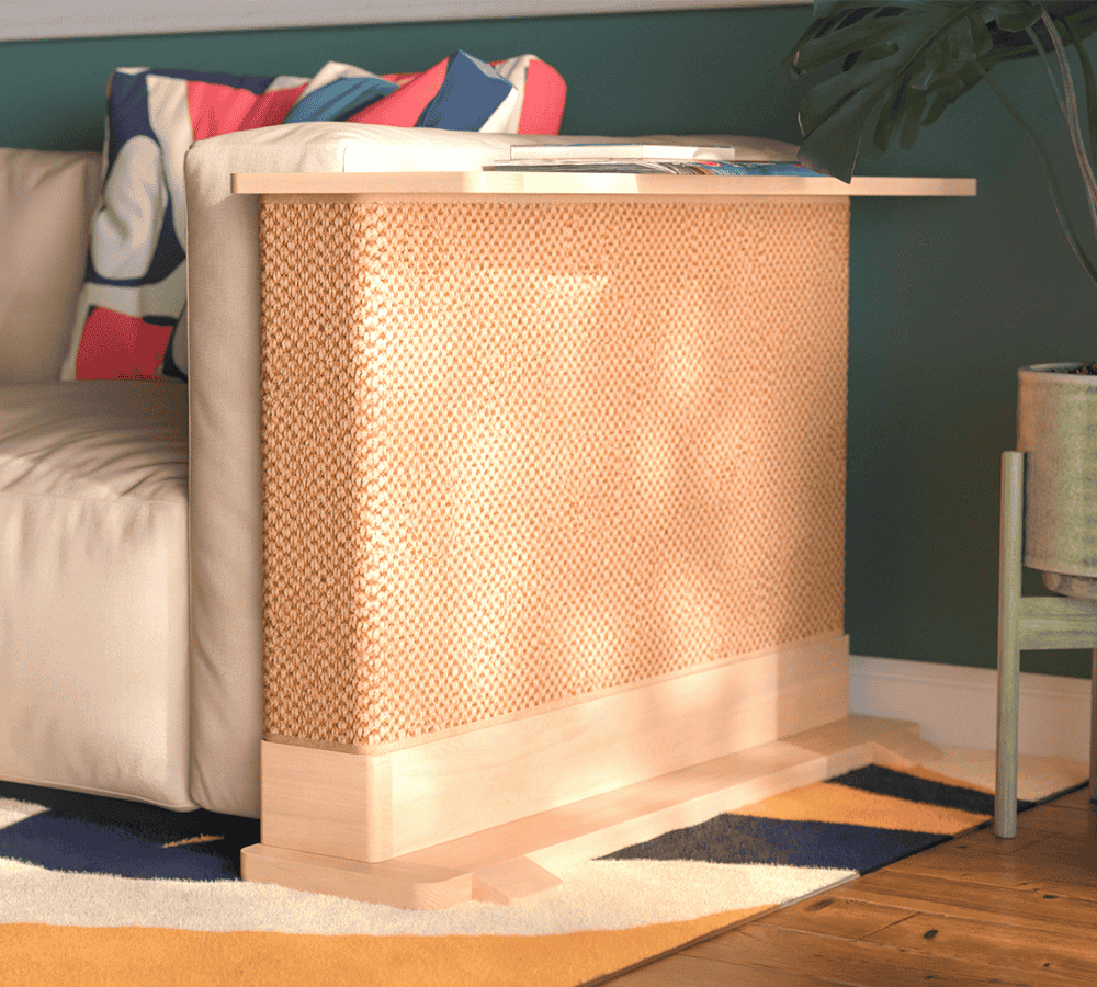 A Cat-e-Corner table placed next to a sofa, integrating a cat's scratching post with a small table, in a room with a plant and a colorful cushion.