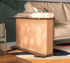 A Cat-e-Corner table placed next to a sofa, integrating a cat's scratching post with a small table, in a room with a plant and a colorful cushion.