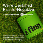 The green container with Finn logo on grass showcases the Allergy & Itch Supplement For Dogs by Finn. It states, Were Certified Plastic-Negative in partnership with rePurpose, using natural ingredients. Finn recovers double the plastic used and supports immune defense while prioritizing planet well-being.