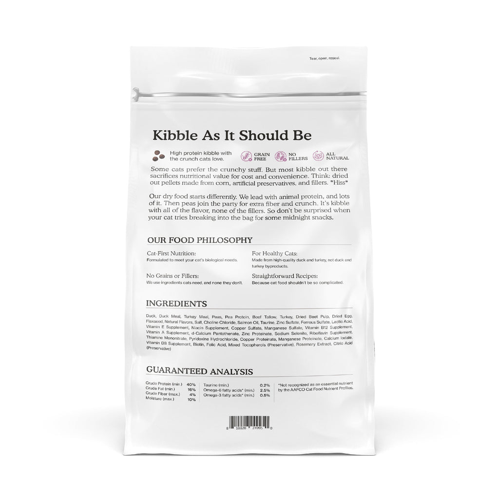 The back of a Cat Person Duck & Turkey Dry Food bag displays its philosophy, ingredients, nutrition facts, and highlights like high protein and all-natural. Black text on a white background.