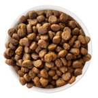 A white bowl filled with round, brown pieces of Cat Person Salmon & Tuna Dry Food kibble, viewed from above on a white background.