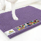 Angled view of Muddy Mat anti-mud dog door mat in lavender showing chenille surface and a dog’s paw on a white floor