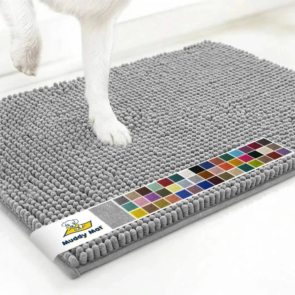 Angled view of Muddy Mat® Anti-Mud Dog Door Mat showcasing dense chenille nubs in light grey with dog’s paws on white floor