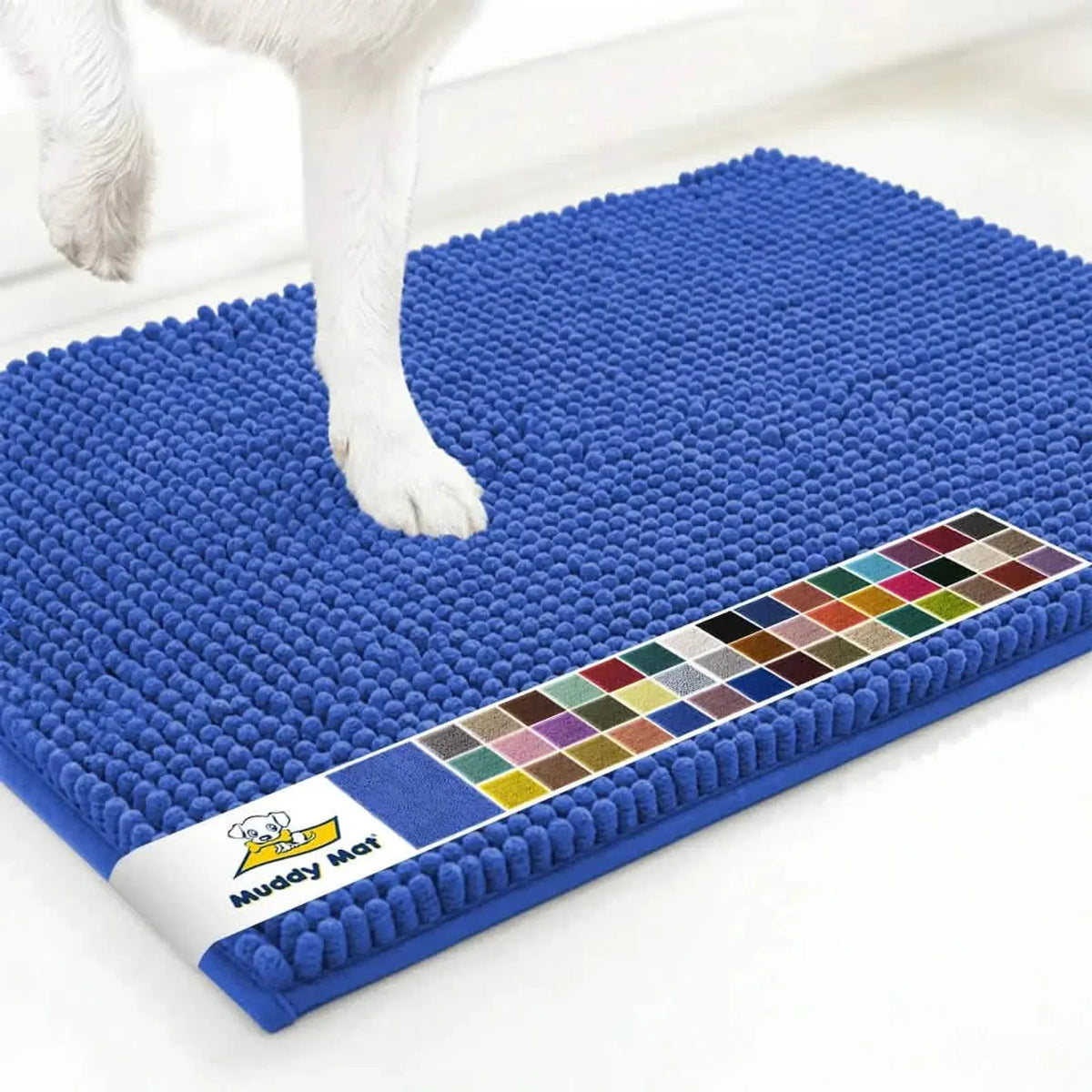 Top view of Periwinkle Muddy Mat anti-mud dog door mat showing dense chenille nubs and a dog’s front paw on a white floor
