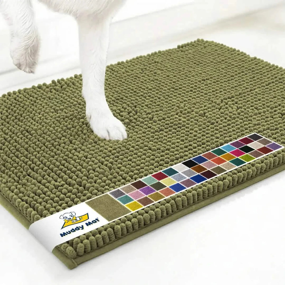 Close-up top view of Muddy Mat anti-mud dog door mat sage showcasing dense chenille nubs with white floor and a dog’s paw for scale