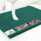 Top-down view of Muddy Mat Anti-Mud Dog Door Mat in slate blue showcasing textured chenille surface with a dog paw on a white floor