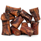 Close-up of smoked beef marrow bone showcasing meaty marrow and smoked exterior on white background